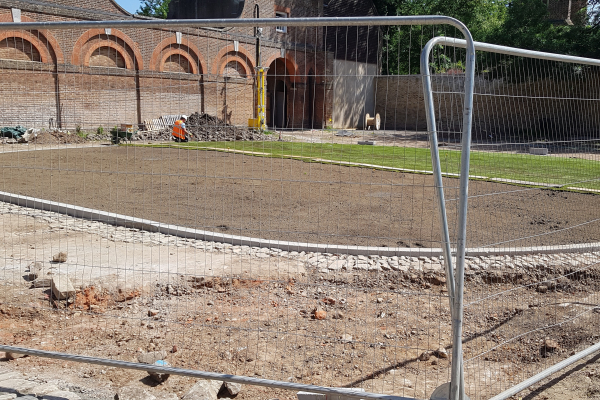 The courtyard being turfed at Cranford Park