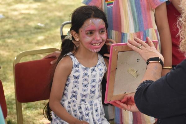 A girl has just had her face painted at Picnic in the Park