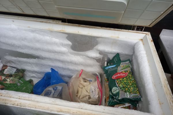 Dirty chest freezer storing unlabelled and unverified food items