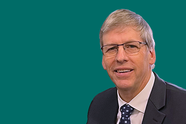 Headshot of Cllr Ian Edwards against a plain green background