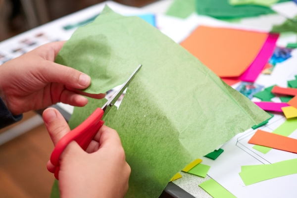 Image of a someone cutting paper