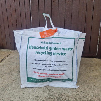 Garden waste sack with garden waste tag attached to the handle