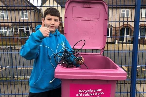 A pink wheelie bin branded for the Cable Challenge recycling competition