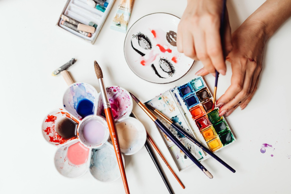 Photo of hands with painting materials