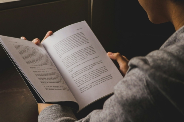 Photo of a person reading a book