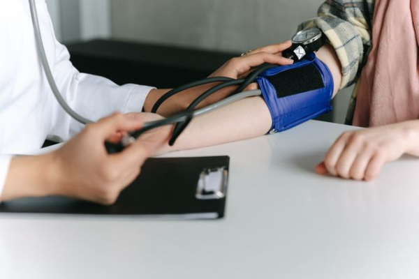 A healthcare worker checking a patient's blood pressure. Source: Pexels.com