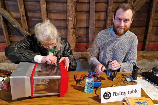Residents at the fixing table at a Repair Day event.
