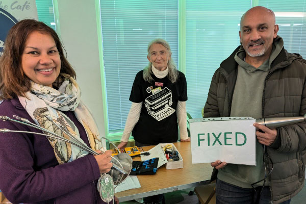3 people holding fixed electricals at a Repair Day event