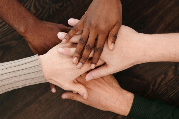 Photo of hands coming together to illustrate community